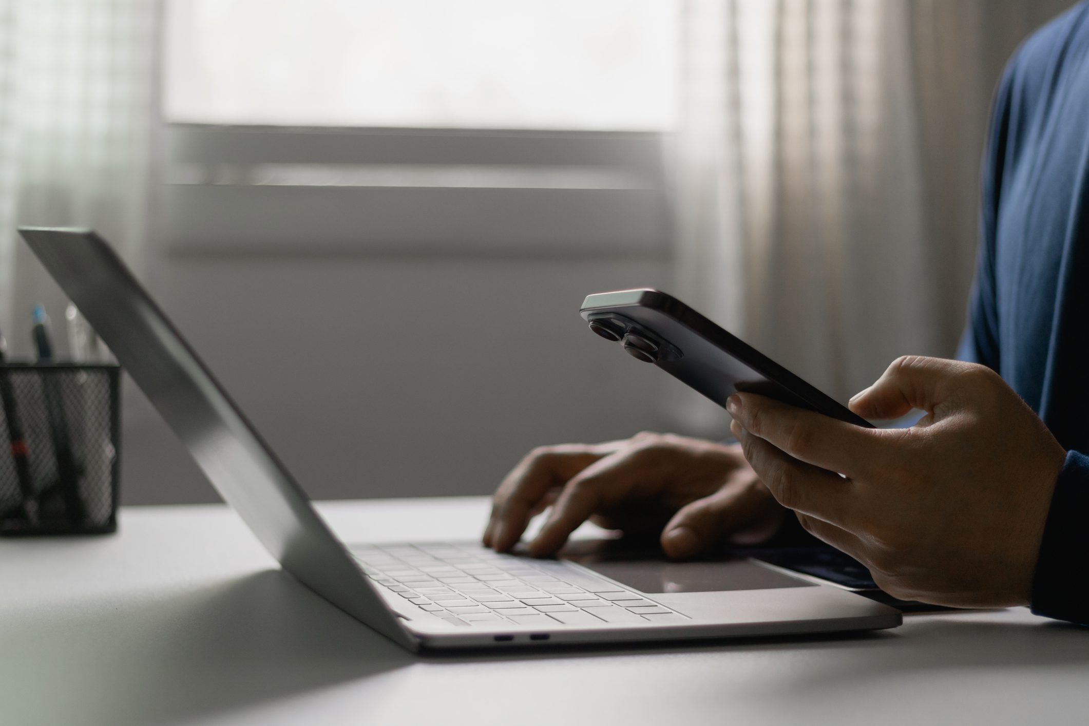 Person using laptop and smartphone